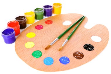 Wooden art palette with paint and brushes isolated on white clipart