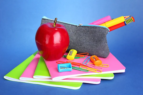 Pencil box with school equipment on blue background — Stock Photo, Image