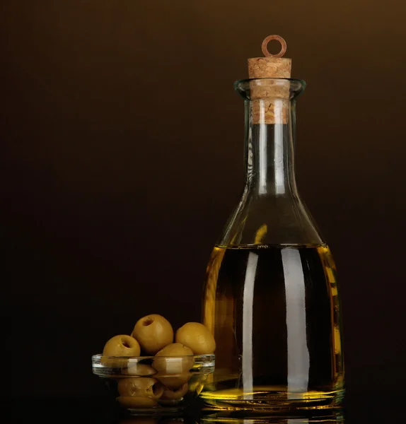 Original glass bottle with oil on dark color background — Stock Photo, Image