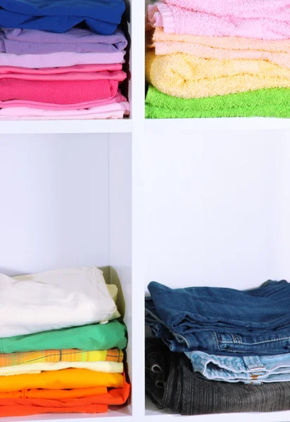 Clothes neatly folded on shelves — Stock Photo, Image