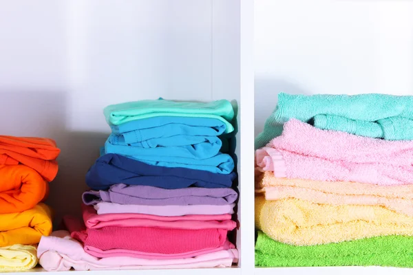 Clothes neatly folded on shelves — Stock Photo, Image