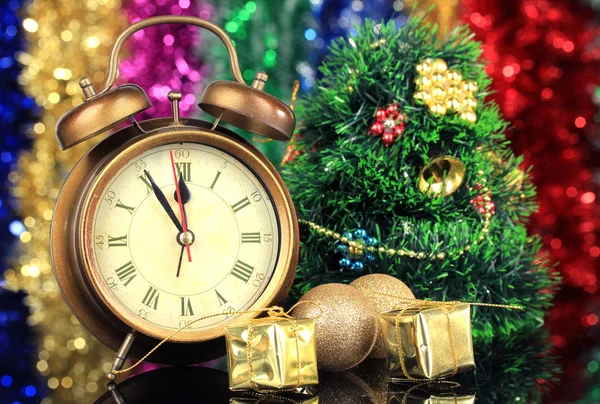 Composition of clock and christmas decorations on bright background — Stock Photo, Image