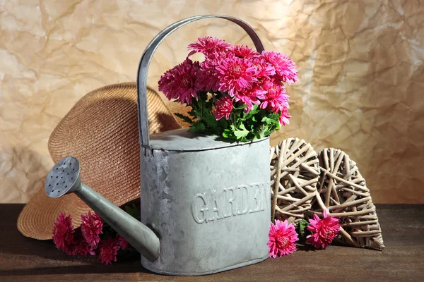 Bouquet de chrysanthème rose en arrosoir sur table en bois — Photo