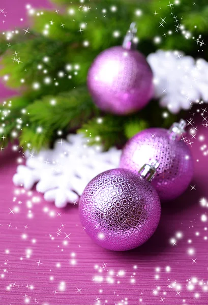 Christmas balls on fir tree, on color background — Stock Photo, Image