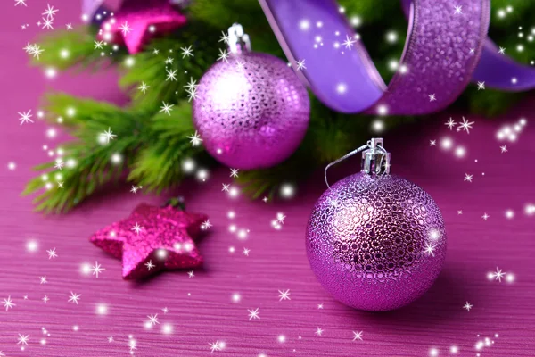 Christmas balls on fir tree, on color background — Stock Photo, Image