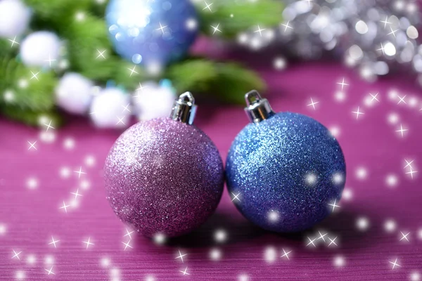 Christmas balls on fir tree, on color background — Stock Photo, Image