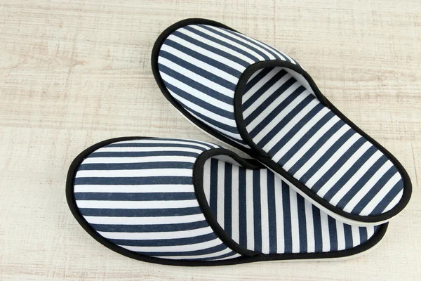 Striped slippers on wooden background — Stock Photo, Image