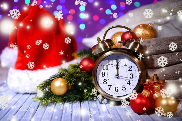 Composition with retro alarm clock and Christmas decoration on bright background — Stock Photo, Image