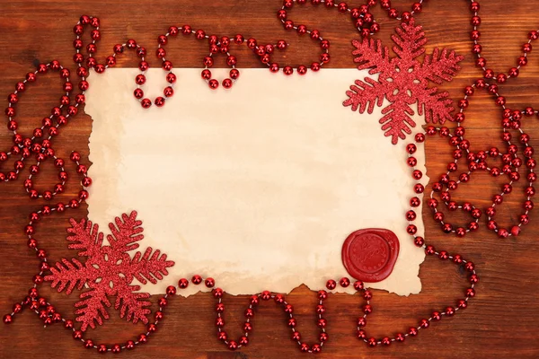 Frame with vintage paper and Christmas decorations on wooden background — Stock Photo, Image