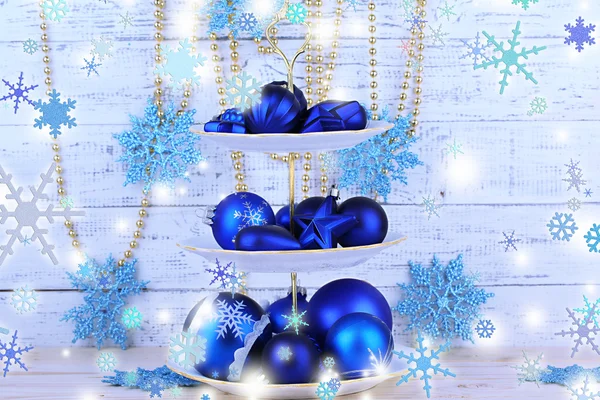 Christmas decorations on dessert stand, on color wooden background — Stock Photo, Image