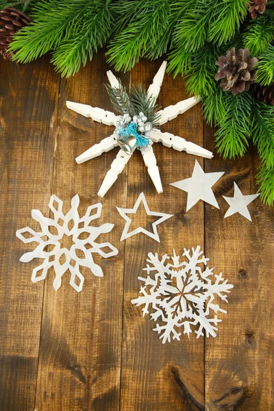 Beautiful snowflakes with fir branch on wooden background — Stock Photo, Image