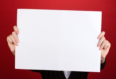 Woman holding blank sign in front her face, on color background clipart
