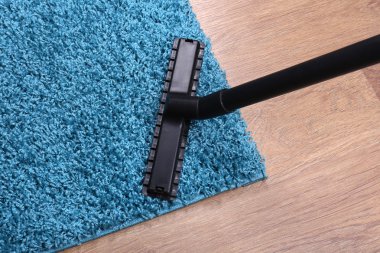 Vacuuming carpet in house clipart
