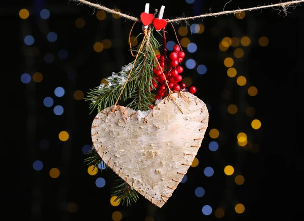 Decorative heart on rope on shiny background — Stock Photo, Image