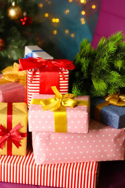 Christmas gift boxes on Christmas tree background — Stock Photo, Image