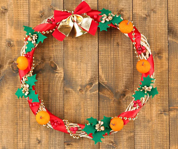 Beautiful Christmas wreath, on wooden background — Stock Photo, Image