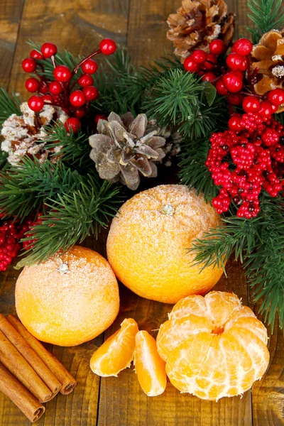 Christmas composition with frosted ripe tangerines on wooden background — Stock Photo, Image