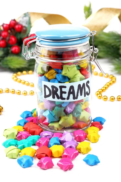 Paper stars with dreams in jar on white background — Stock Photo, Image