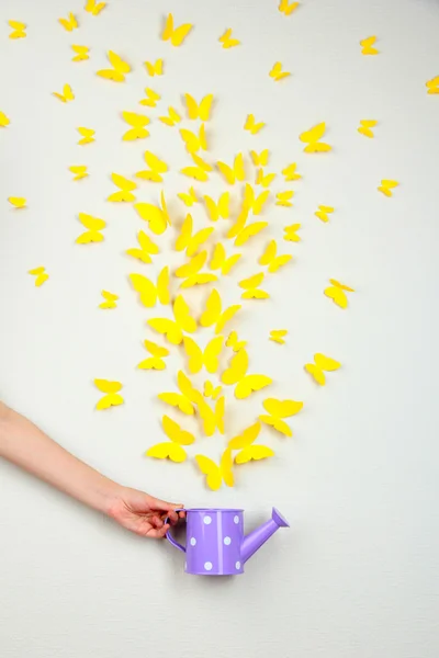 Paper yellow butterflies fly out of watering can — Stock Photo, Image