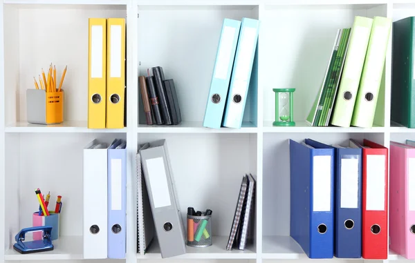 White office shelves with folders and different stationery, close up — Stock Photo, Image