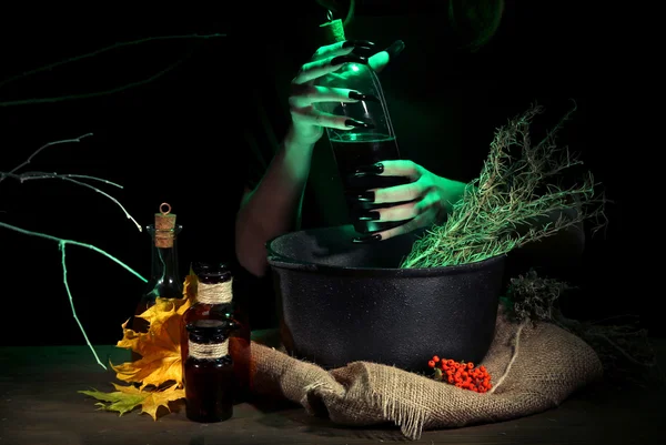 Witch in scary Halloween laboratory on dark color background — Stock Photo, Image