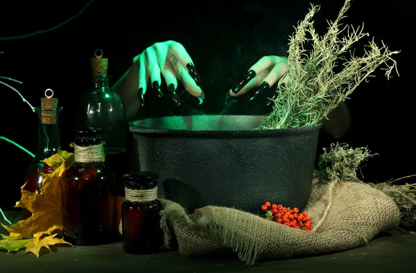 Witch in scary Halloween laboratory on dark color background — Stock Photo, Image