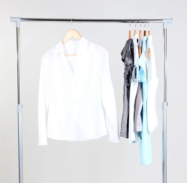 Office female clothes on hangers, on gray background — Stock Photo, Image