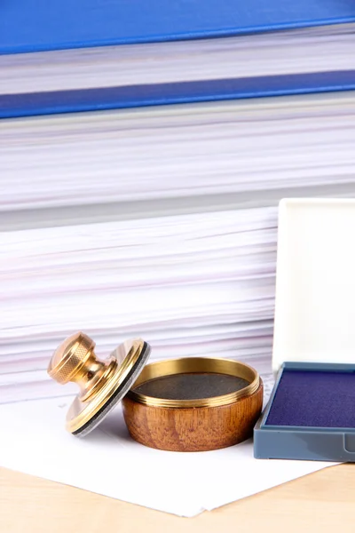 Wooden stamp and papers on table — Stock Photo, Image