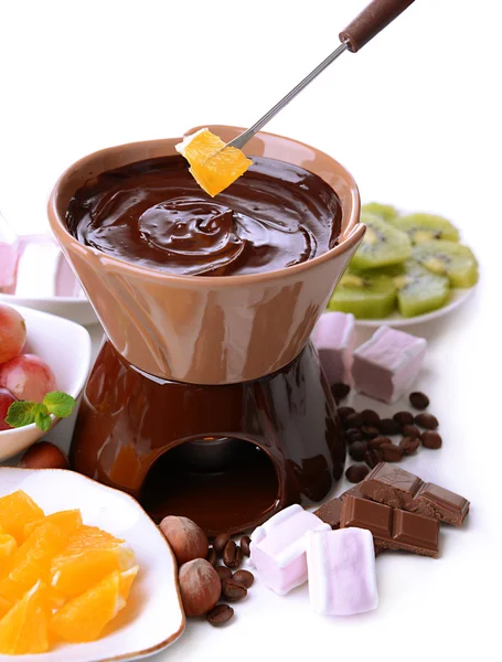 Chocolate fondue with marshmallow candies and fruits, isolated on white