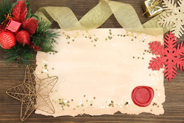 Frame with vintage paper and Christmas decorations on wooden background — Stock Photo, Image
