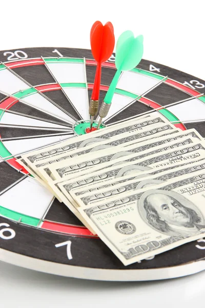 Dart on dartboard and money close up. Concept of success.