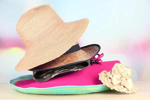 Many hats on table on light background — Stock Photo, Image