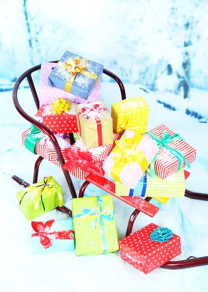 Sledge with Christmas presents, on winter background — Stock Photo, Image