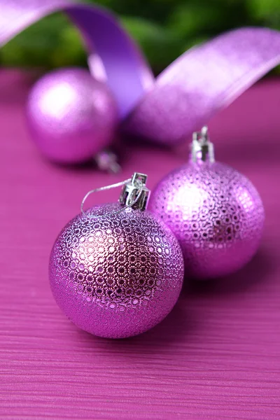 Christmas balls on fir tree, on color background — Stock Photo, Image