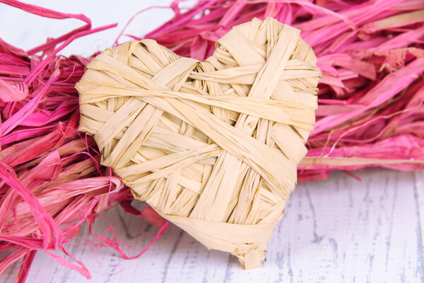 Decorative straw for hand made and heart of straw, on wooden background