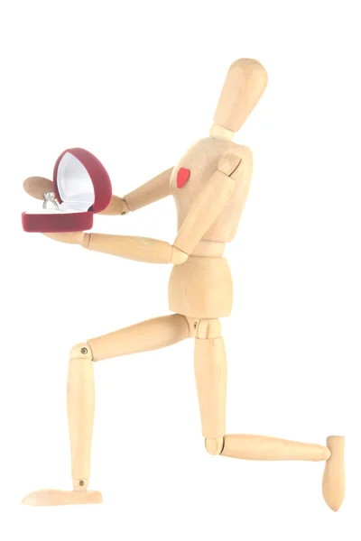 Wooden mannequin holding box with ring isolated on white — Stock Photo, Image