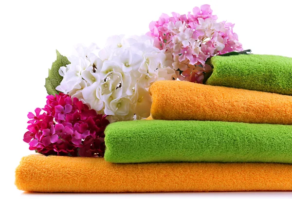 Colorful towels and flowers, isolated on white — Stock Photo, Image