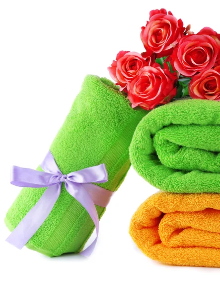 Colorful towels and flowers, isolated on white — Stock Photo, Image