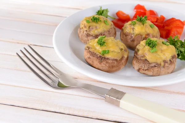 Stuffed mushrooms on plate on table on light background — Stock Photo, Image