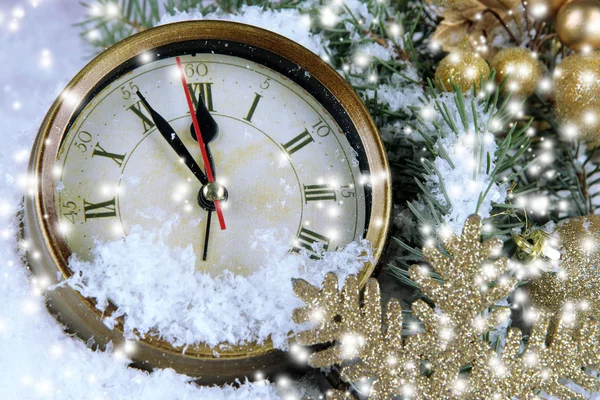 Clock with fir branches and Christmas decorations under snow close up — Stock Photo, Image