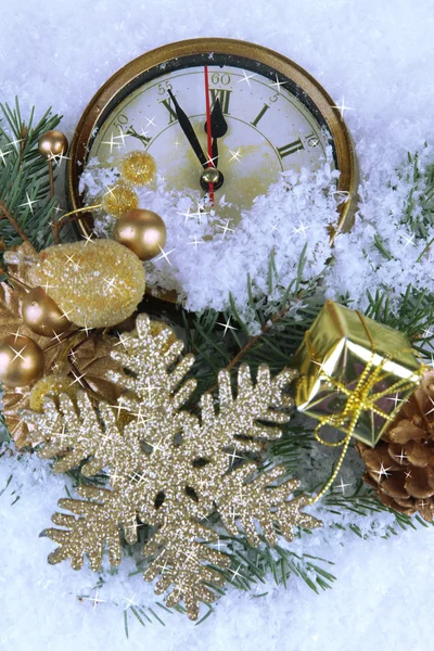 Clock with fir branches and Christmas decorations under snow close up — Stock Photo, Image