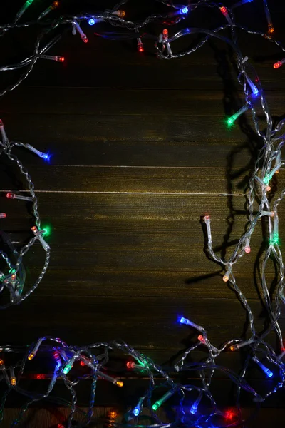 Ahşap arka planda Noel ışıkları — Stok fotoğraf