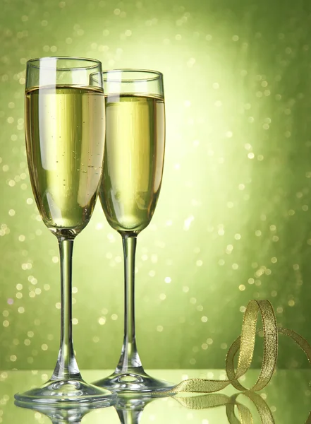 Two glasses of champagne on bright background with lights — Stock Photo, Image