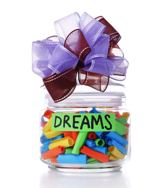 Dreams written on color rolled paper in glass jar, isolated on white — Stock Photo, Image