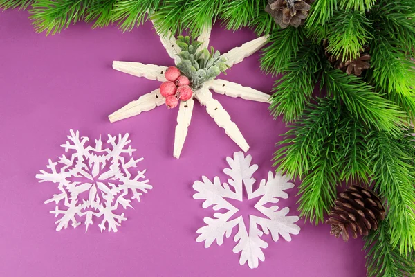 Schöne Schneeflocken mit Tannenzweig auf violettem Hintergrund — Stockfoto