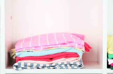 Clothes neatly folded on shelves