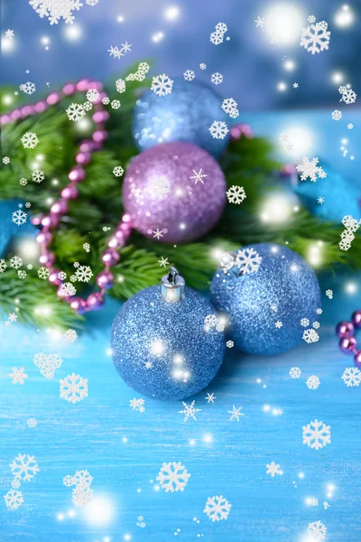 Christmas balls on fir tree, on color background — Stock Photo, Image