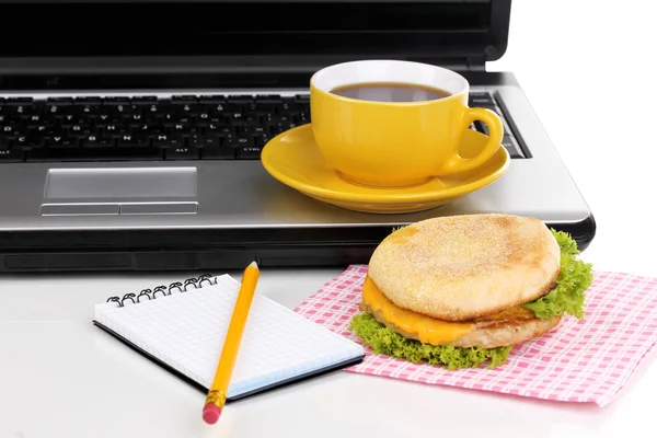 Eating at work place near laptop — Stock Photo, Image