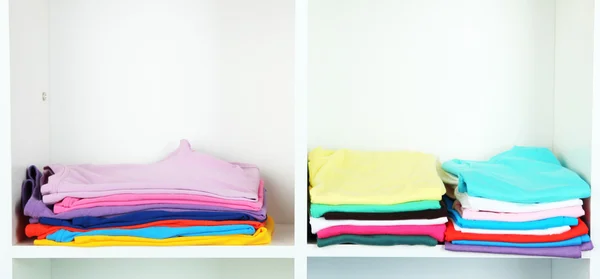 Clothes neatly folded on shelves — Stock Photo, Image