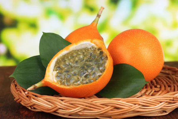 Passion fruits on wicker mat on table on bright background — Stock Photo, Image